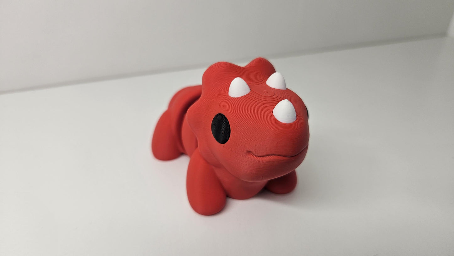 Medium Sized Flexible Triceratops In Red. Articulated Fidget Animal
