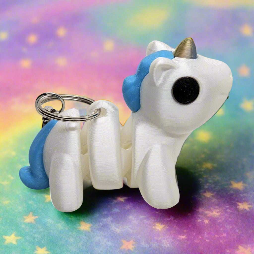 Flexible Unicorn Keyring / Key Chain in Shining White with a Gold & Blue Horn. Articulated Fidget Animal