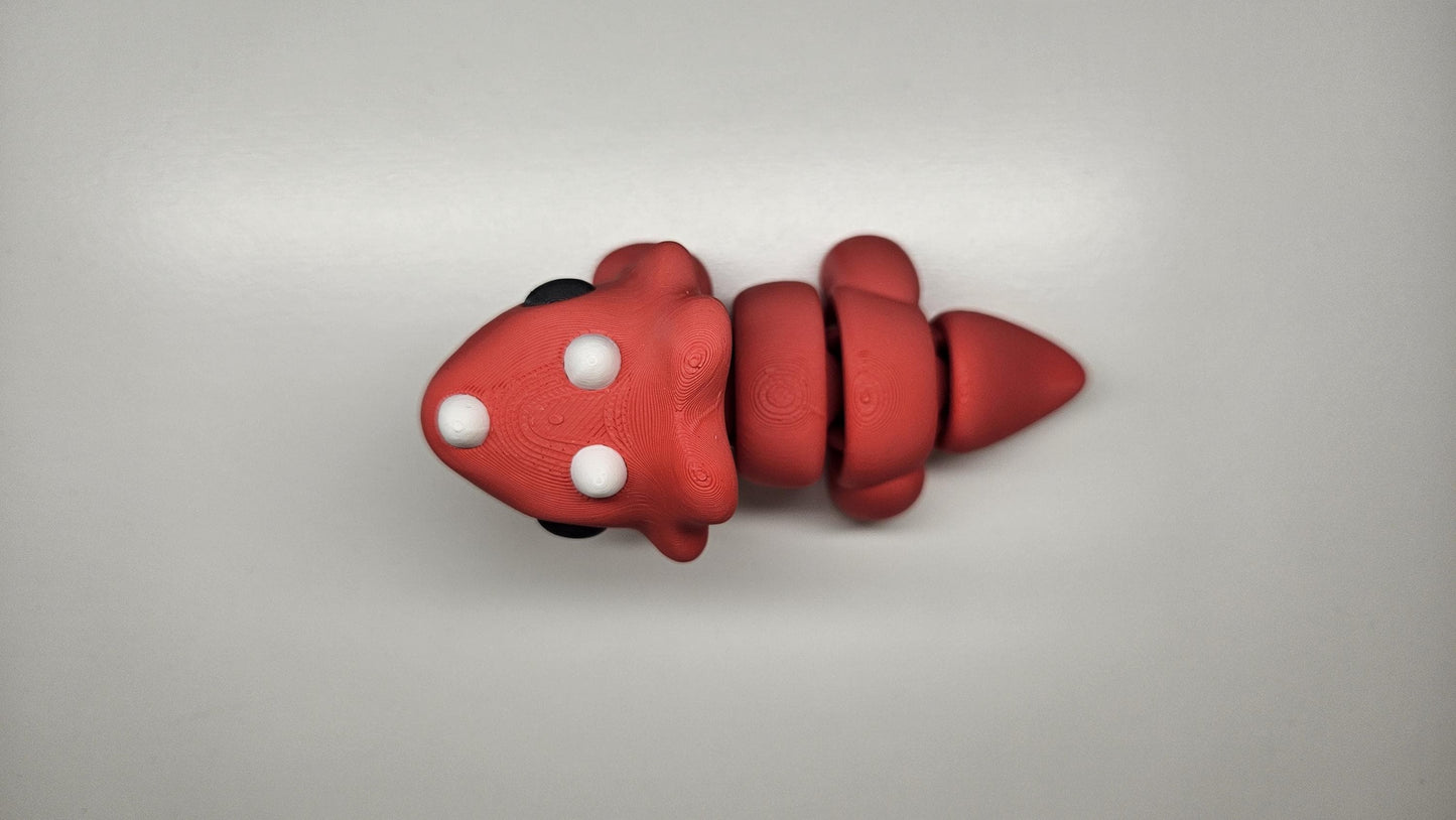 Medium Sized Flexible Triceratops In Red. Articulated Fidget Animal