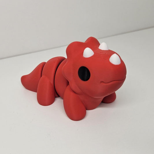 Medium Sized Flexible Triceratops In Red. Articulated Fidget Animal