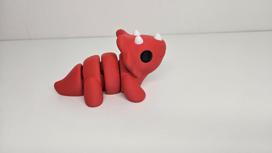 Medium Sized Flexible Triceratops In Red. Articulated Fidget Animal